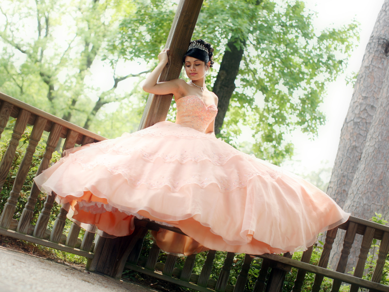 Girl in a beautiful gown at her Quinceanera celebration.